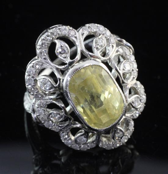 A white gold, yellow sapphire and diamond cluster dress ring, size M.